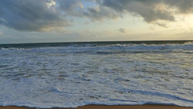 Ocean waves on the sunset tima. Slow-motion