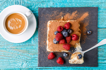 Tiramisu cake with raspberries and blueberries. Homemade tiramisu dessert