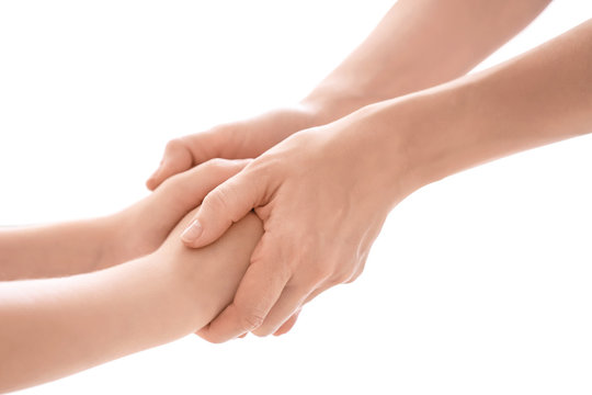 Mother and daughter holding hands together on white background, closeup
