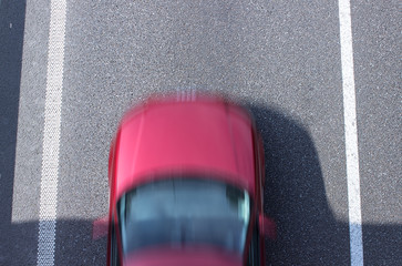 Fragment of the road with a moving car