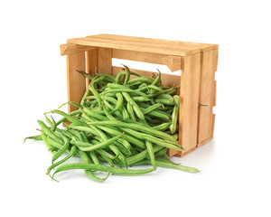 Wooden crate with fresh green beans on white background