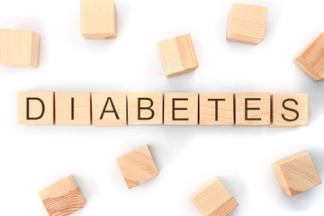 Composition with word Diabetes made of wooden cubes on white background