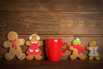 Tasty Christmas homemade cookies and cup on wooden background