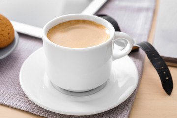 Cup of aromatic morning coffee on table