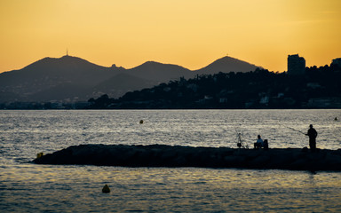 Bright yellow sunset on beach with sunset in Juan les Pins, Cote d'Azur, France