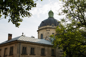 Lviv, Ukraine: Panorama of Pidvalna street with the dome of Dominican Church, Lvov and trees framing