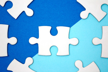 Leadership business concept - jigsaw on blue geometry background. Minimal style. Flat lay.
