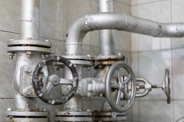 Handle valve with steel pipe in industrial plant.