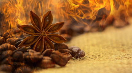 coffee beans and star anise on coarse fabric and fire