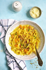 Tagliatelle with pumpkin in a cream sauce.Top view.