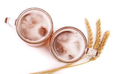 glass of foamy beer with wheat isolated on white background. Top view