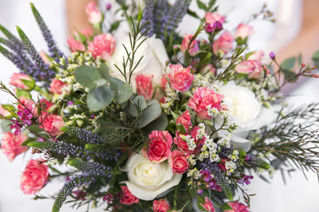 wedding colourful bouquet in bride's hands white background