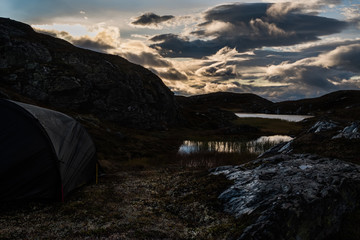 Tent in scenic mountain sunrise