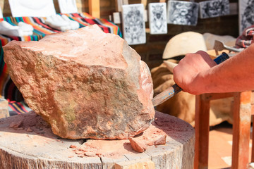 Artisan stonecutter with ancient tools of an ancient artisan stonecutter in Discovery Medieval Fair in a town called Palos de la Frontera