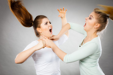 Two agressive women having argue fight