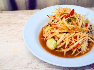 Perspective top view Thai local traditional street stall food: spicy papaya salad 