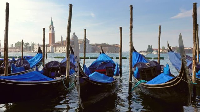 Traditional Gondolas on Canal Grande with San Giorgio Maggiore church in the background, San Marco, Venice, Italy, 4k
