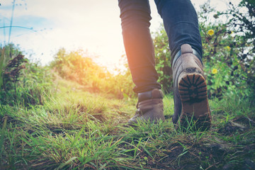 hiking shoes in action on a mountain desert trail path. Close-up of female hikers shoes.