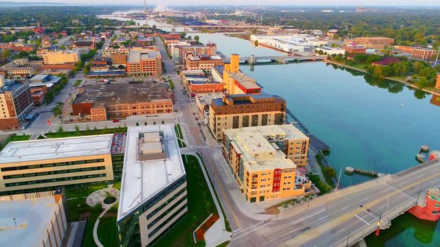 Beautiful downtown Green Bay Wisconsin with Fox River, daybreak aerial flyover.
