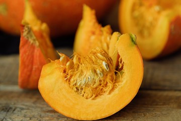 Delicious fresh orange pumpkin on wooden table 