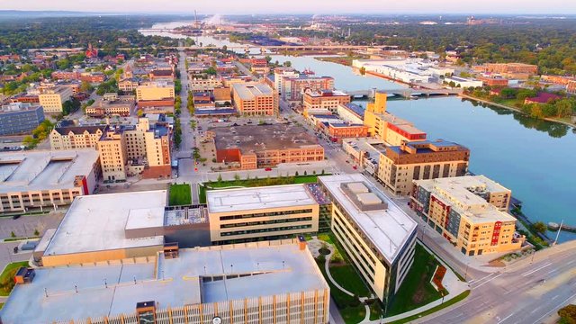 Beautiful downtown Green Bay Wisconsin with Fox River, daybreak aerial flyover.
