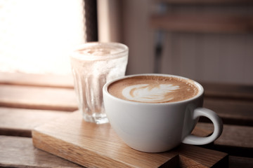 A cup of coffee put on wooden board