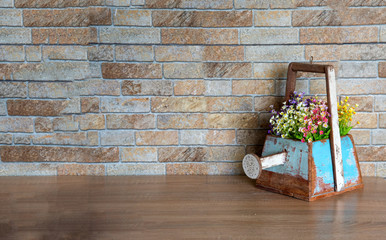 Wooden vase with watering shaped on wood table for decoration in gardening or home and put the colorful flowers in vase
