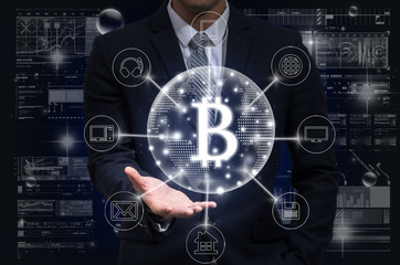 Businessman hand holding the bitcoins text financial technology or FINTECH connection with omni channel over the digital virtual screen background,, Showing the cryptocurrency or digital money