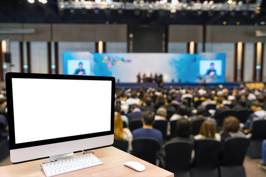 Computer Set Showing The White Screen Over The Abstract Blurred Photo Of Conference Hall Or Seminar Room With Attende Background, Business And Education Concept