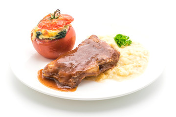 grilled rib pork with mash potatoes and spinach baked in tomato