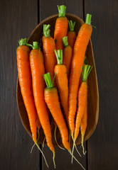 fresh carrots on wooden surface
