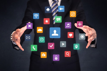 Businessman holding colorful applications