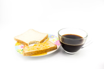 Black coffee in transparent glass with slide bread on dish