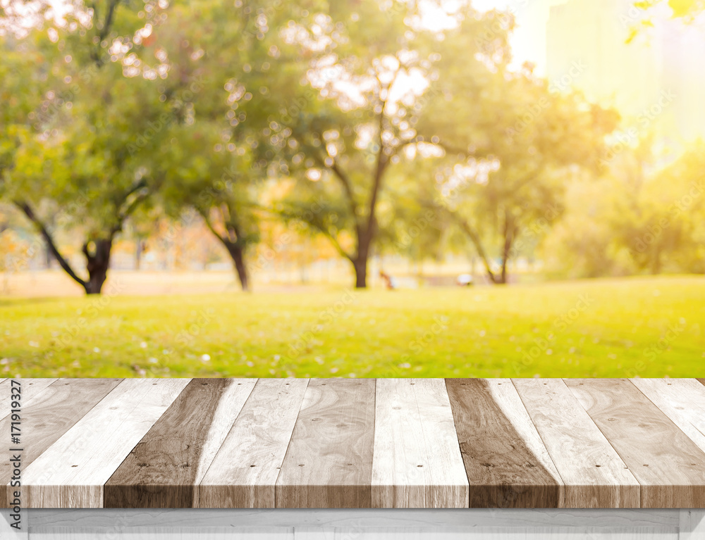 Aufkleber empty old rustic wood plank table top with blur forest tree with sunlight,autumn fall backgorund,moc
