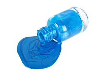 Blue nail polish bottle with splatters isolated on a white background