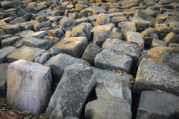 Big gray rock line up on the ground