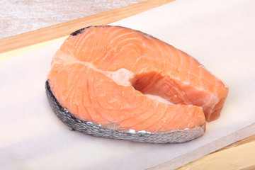 fresh raw salmon with spices on wooden cutting board. ready for cookin