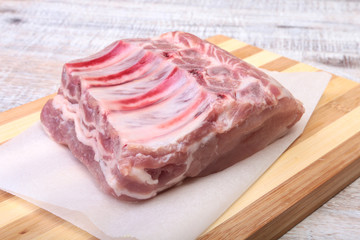 Raw pork chops, spices on cutting board. Ready for cooking.