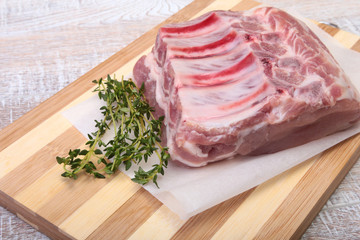 Raw pork chops, spices and rosemary on cutting board. Ready for cooking.