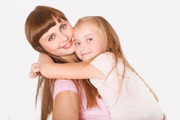 Portrait of beautiful mother and her daughter hugging. Happy family.
