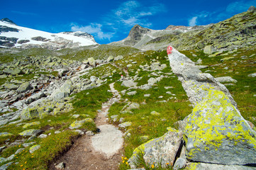  trail mark front of  high mountain and blue sky