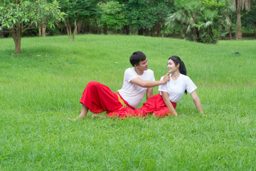 Asian young boy and girls learning Thai dance. Classical Dance in white shirt red loincloth, Demonstrate dance in the garden