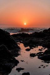 wave on rocks sunset 