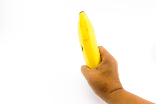 Man hand holding banana isolated on white background