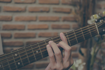 Vintage tone. Asian hand catch acoustic guitar chord