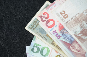 Some banknotes of Georgian lari on a dark background