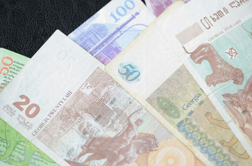 Some banknotes of Georgian lari on a dark background