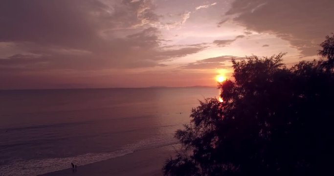 Sunset on Tropical Beach in the Andaman Sea, Aerial Push-Through Reveal Shot
