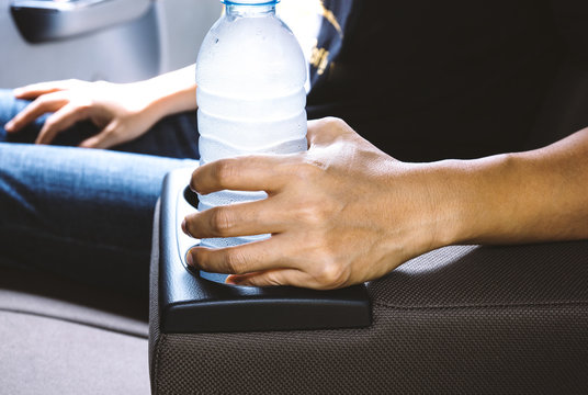 Woman hold drinking water bottle on cup holders