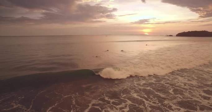 Surfers Waiting For Waves at Sunset on Tropical Thai Beach, Pullback Reveal Shot
